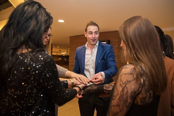 a man in a suit putting his hands on another man's hand